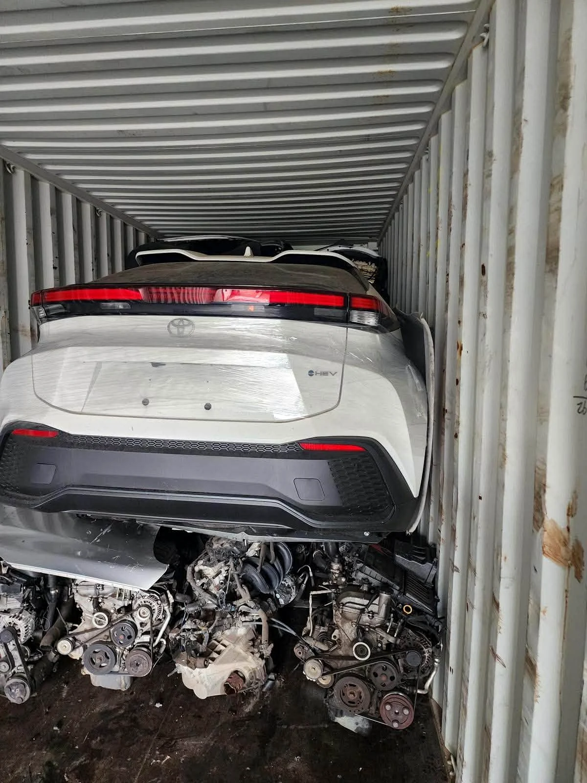 Toyotastic photo of imported vehicle and spare parts inside a shipping container